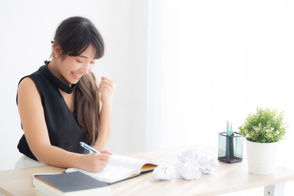  Young Woman Writer Excitedly Writing on Notebook