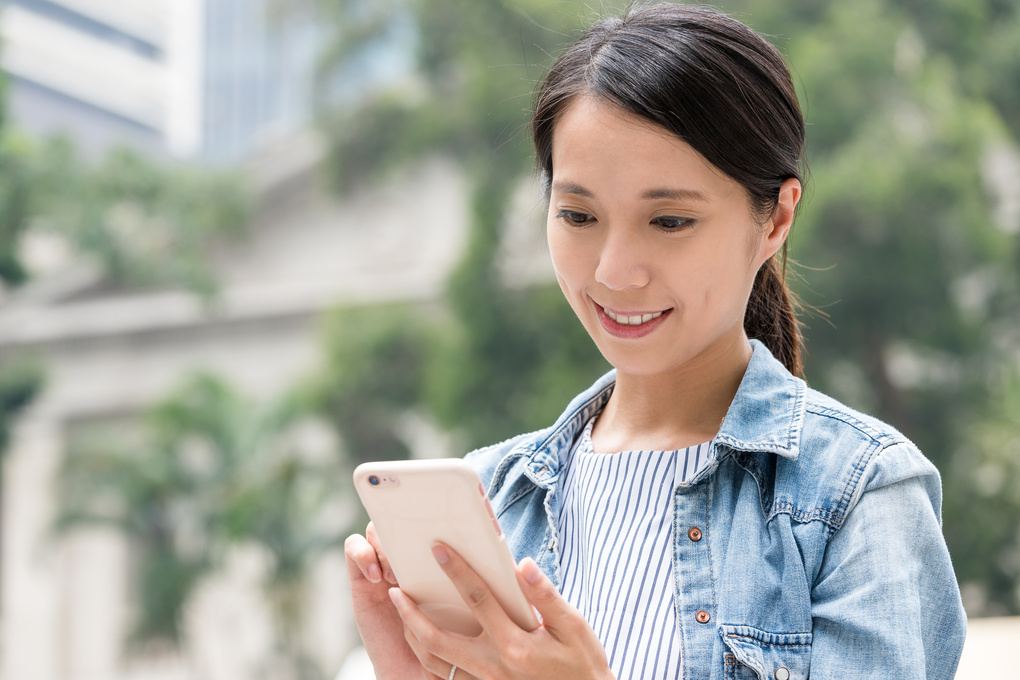 Woman Looking at Mobile Phone